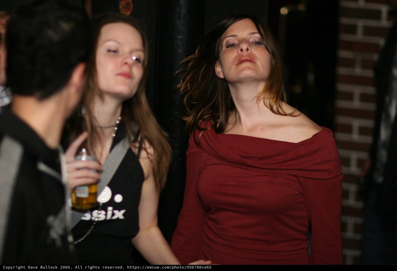 Two Women Dancing at a Dimly Lit Nightclub