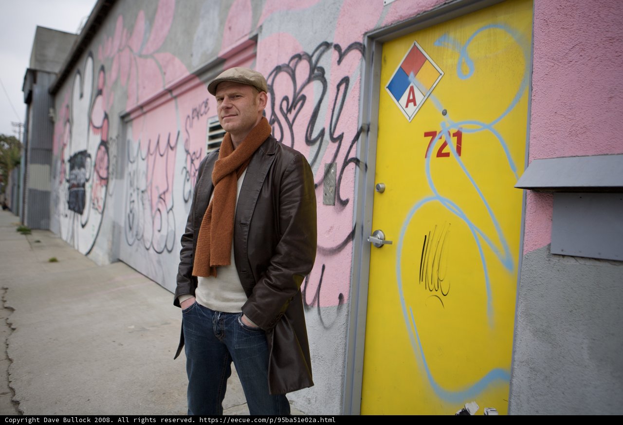 Junkie XL poses in front of urban art