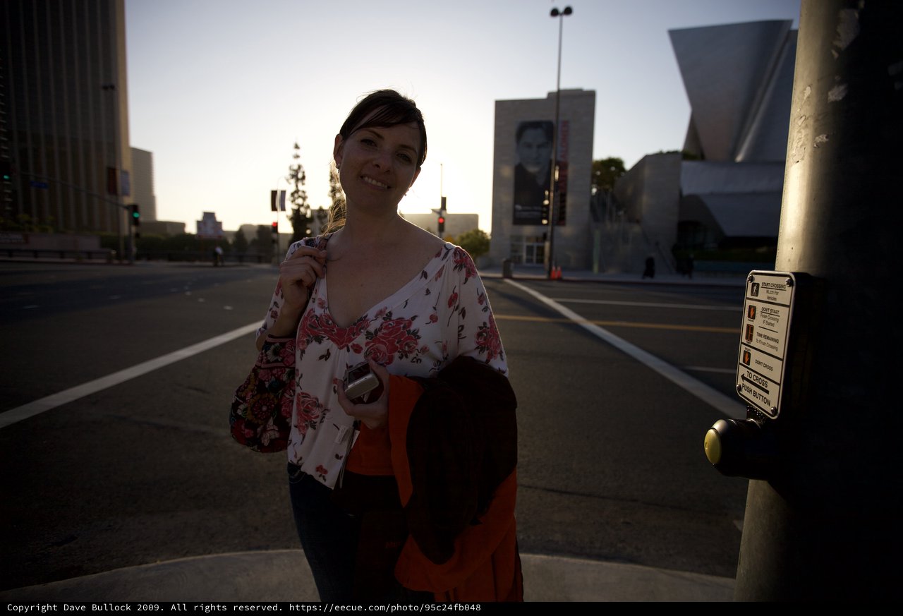 Woman Smiling at Downtown LA Crosswalk at Dusk