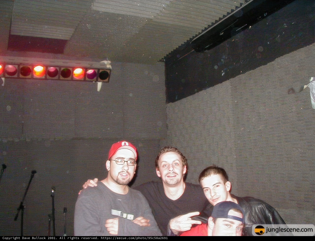 Three Men Strike a Pose on Stage