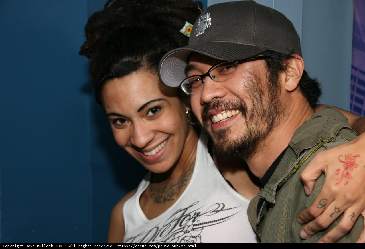 Smiling Couple Showing Off Their Tattoos