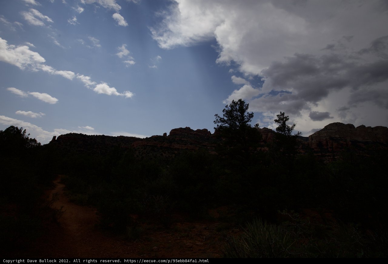 Majestic Cumulus Clouds Over Rocky Landscape