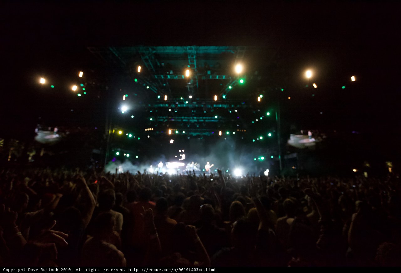 Glowing Crowd Rocks Out Under Green Spotlights