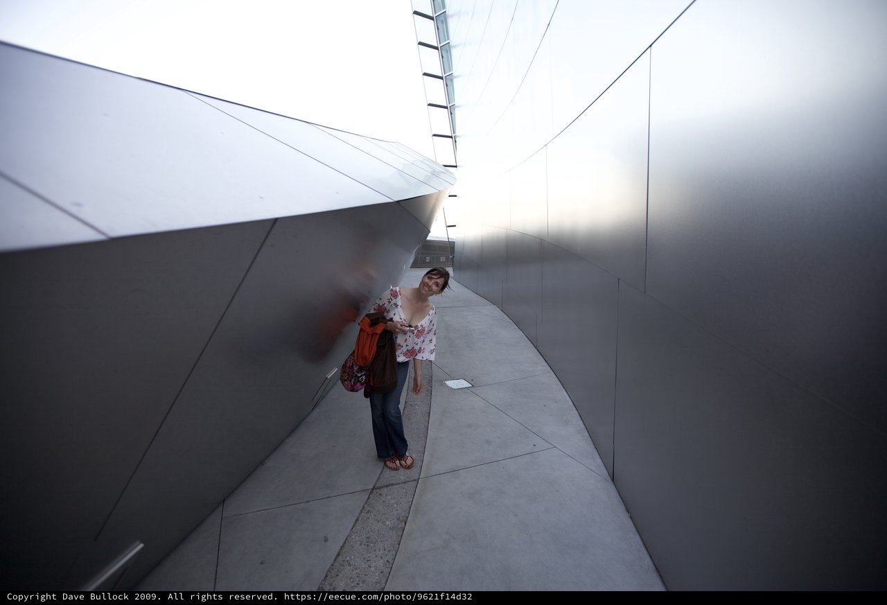 Woman Explores Curved Steel Walls of Walt Disney Concert Hall