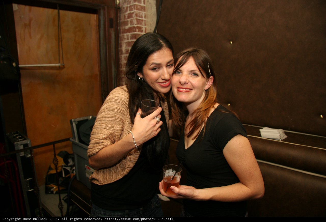Two Friends Celebrating at a Festive Holiday Gathering