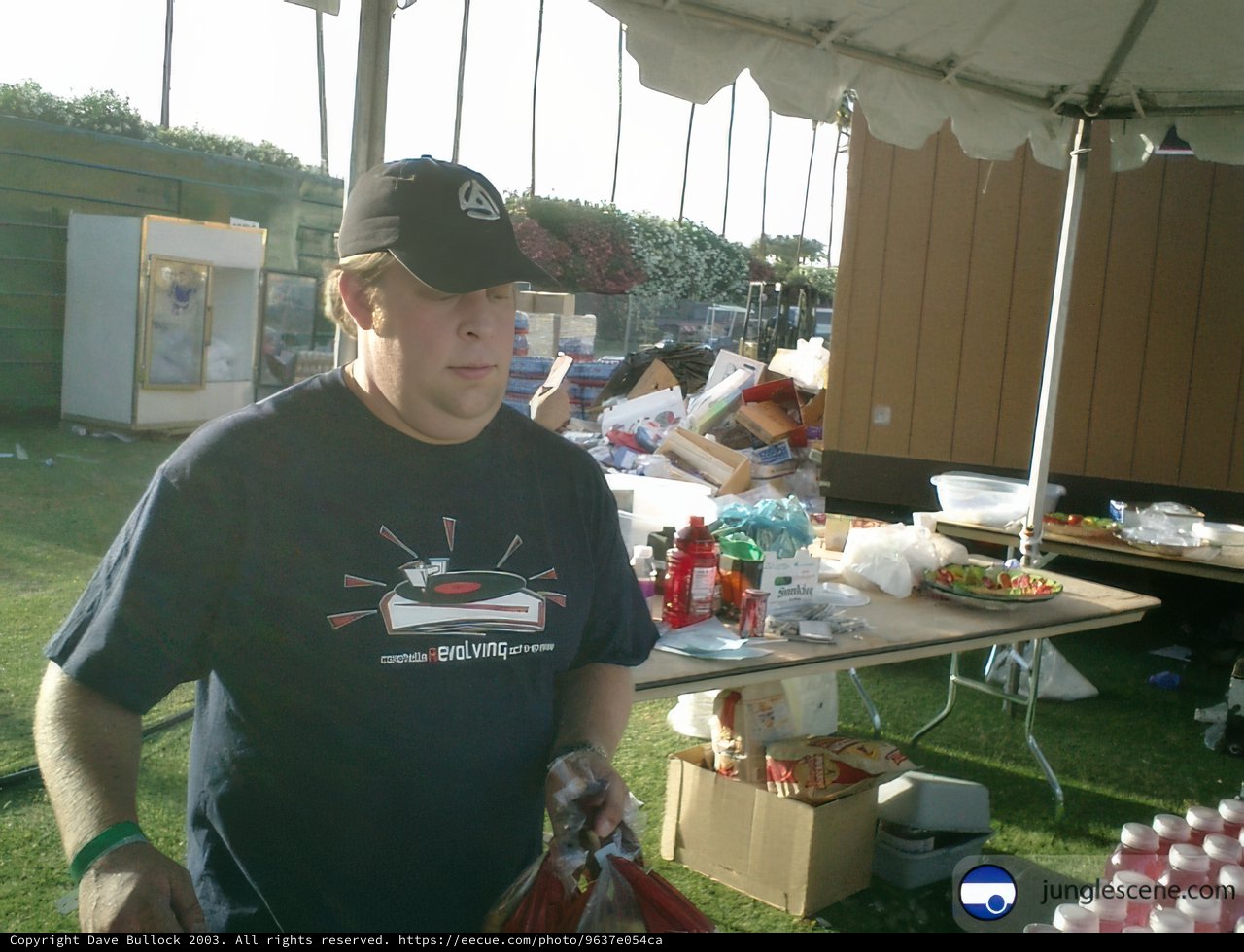 Man in Baseball Cap Enjoying a Meal Outdoors