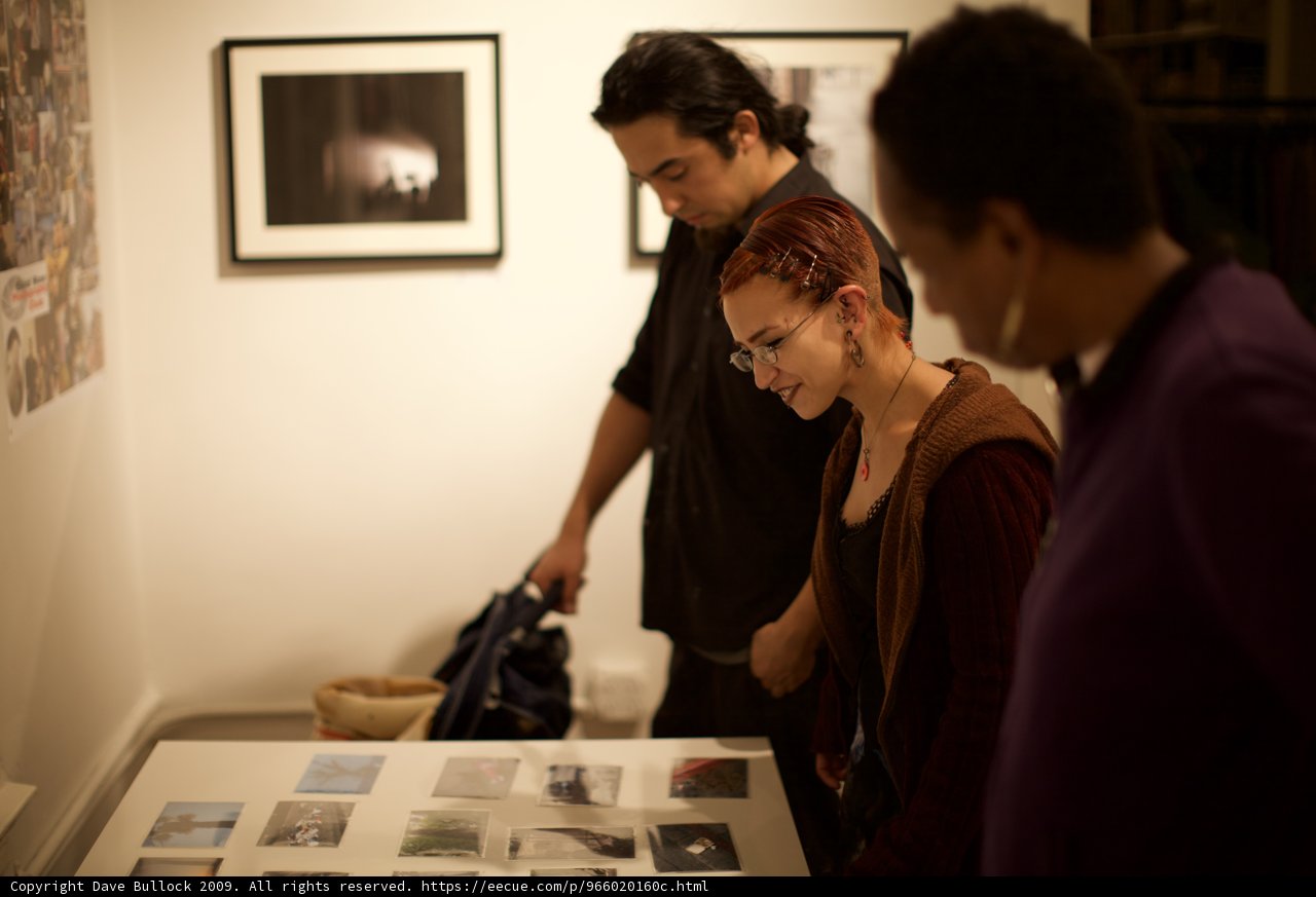 Art Enthusiasts Immersed in Gallery Experience