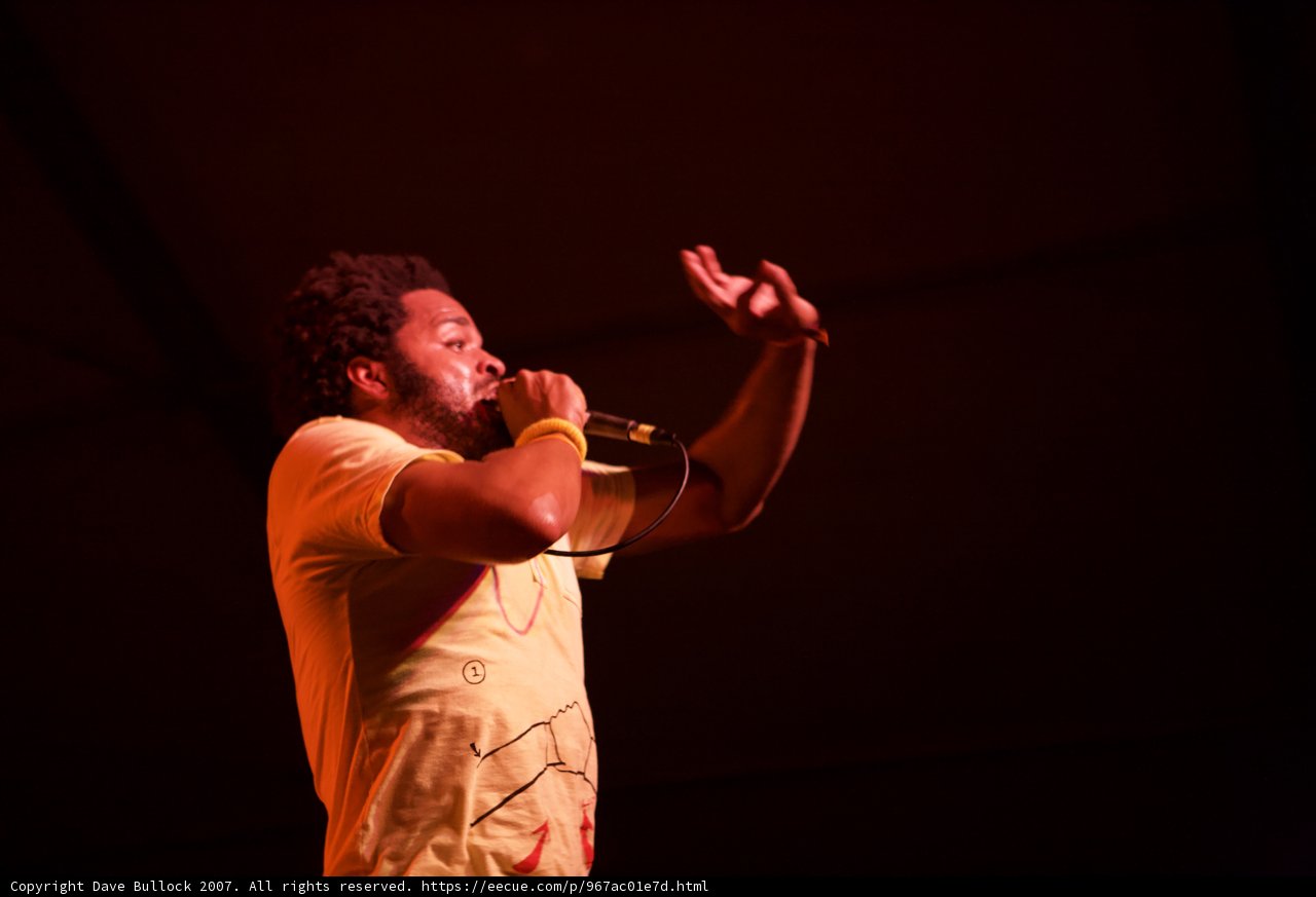 Yellow-Shirted Performer Takes the Stage with Microphone