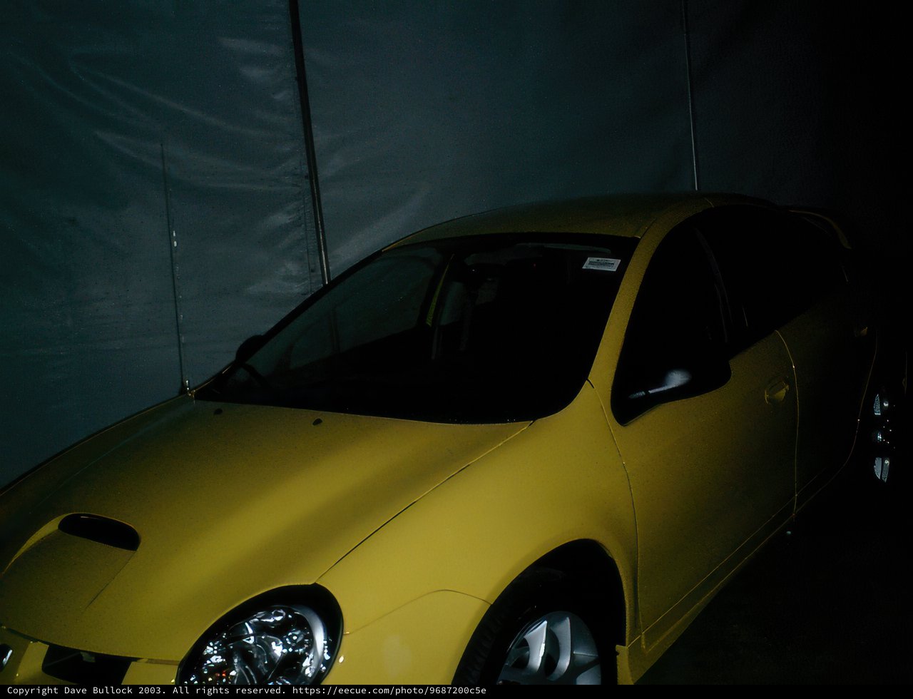 Bright Yellow Sports Car in Dark Arena
