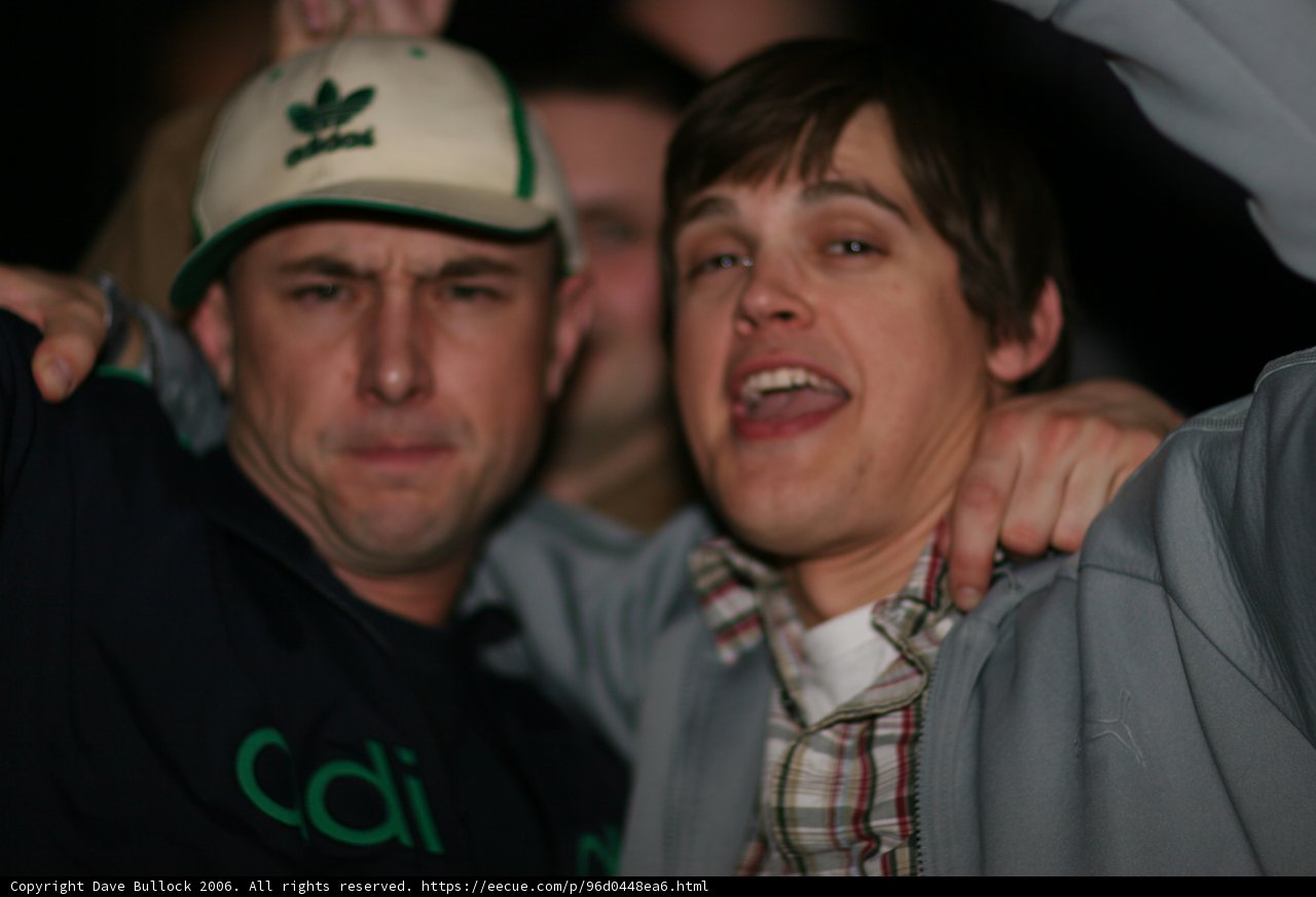 Green Jacketed Man Rocks Baseball Cap