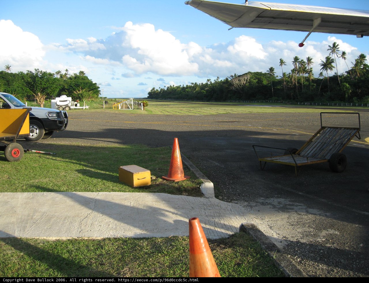 Parked Truck Next to Airplane on Runway