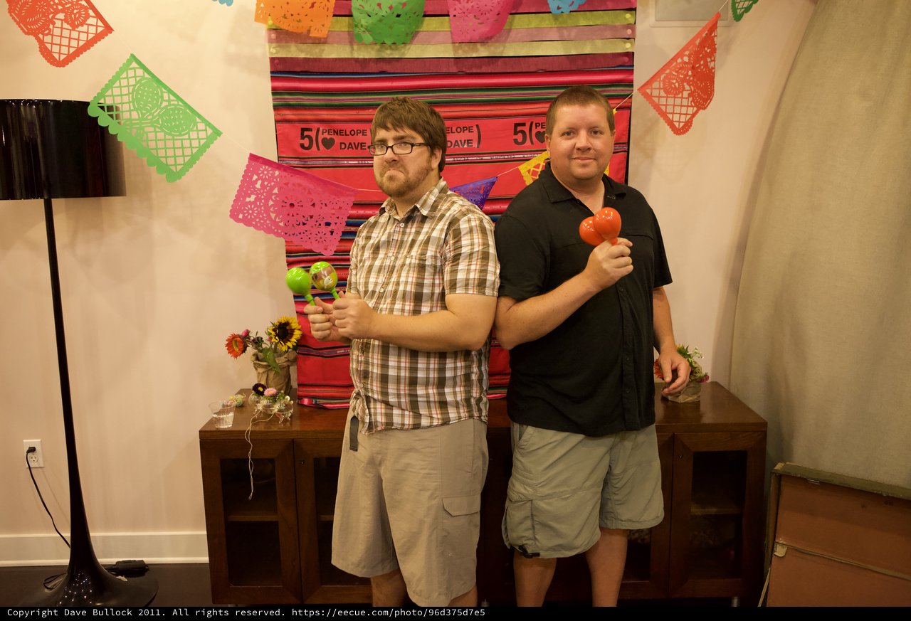 Two Friends Celebrate with Maracas at Fiesta Party
