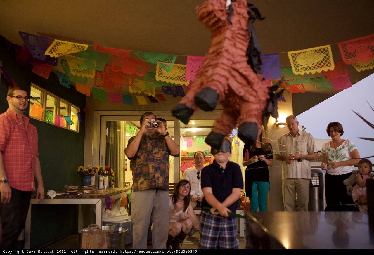 Blindfolded Child Swings at Piñata at Fiesta Party