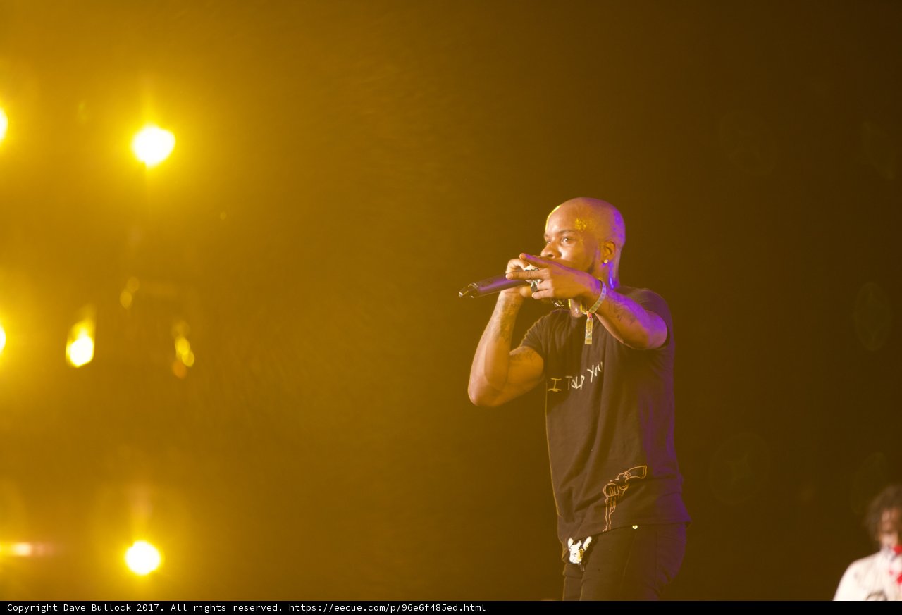 Tory Lanez Lights Up Coachella Stage Caption: Singer and performer Tory Lanez electrifies the crowd with his brass section and powerful vocals as he holds a microphone at Coachella 2017.
