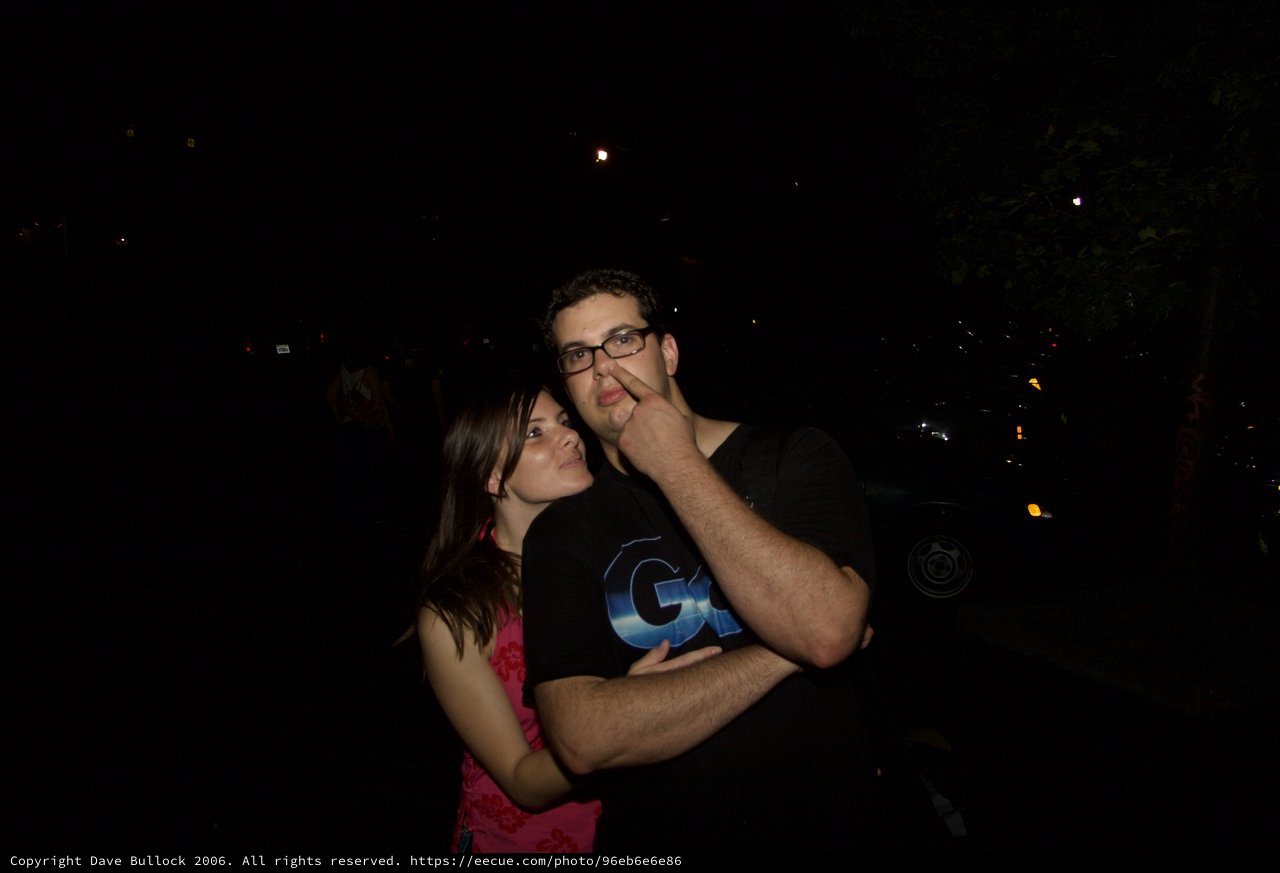 Couple Poses Playfully on a Summer Night Out