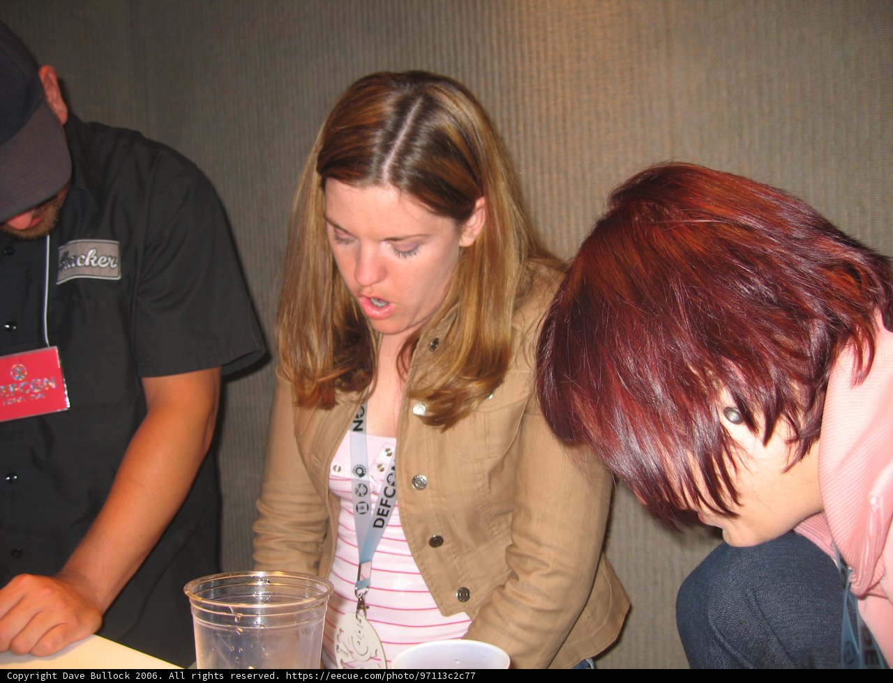 Pink Shirted Woman Sips at Pub Table