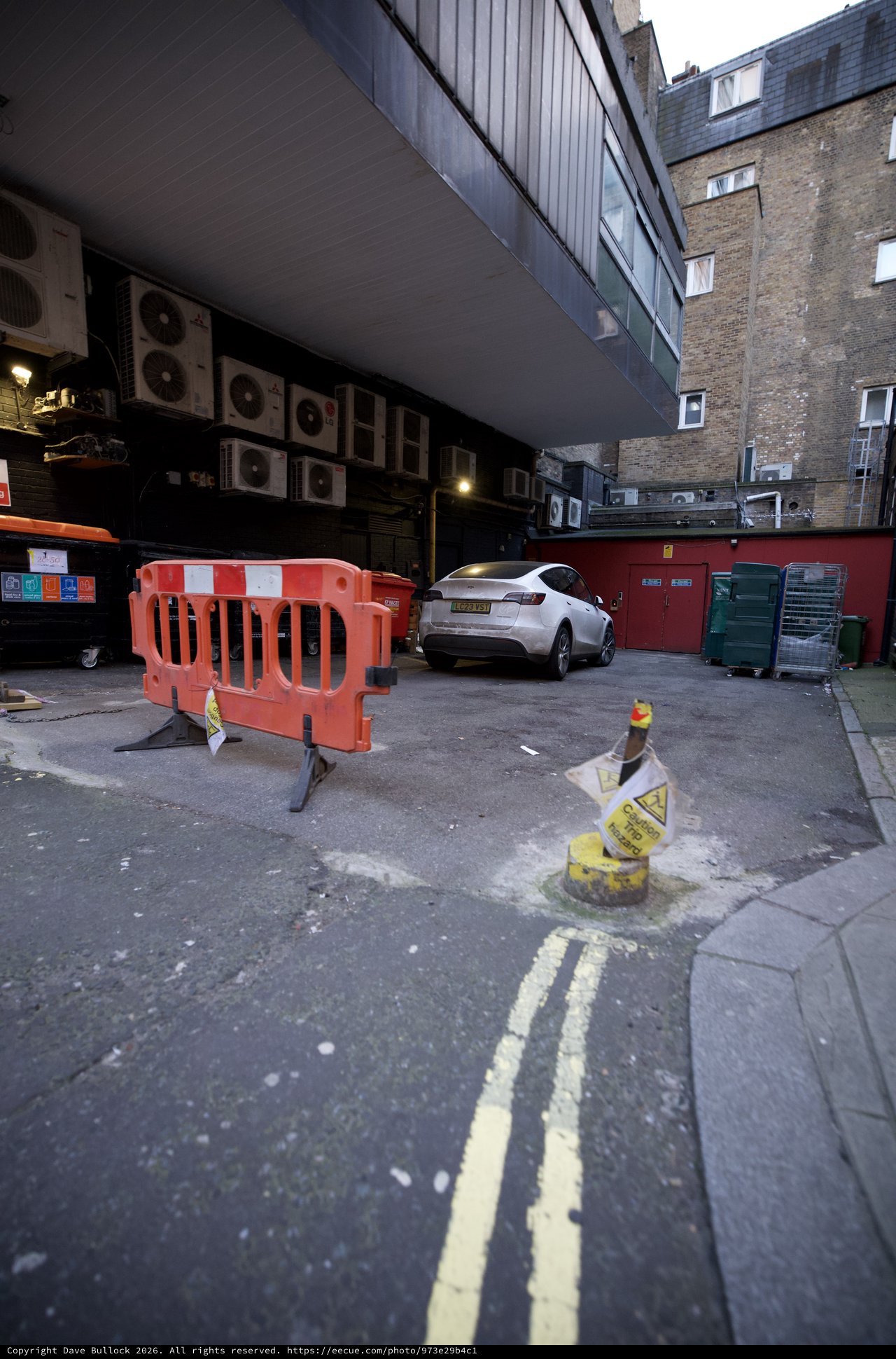 Urban Alley Construction Site with White SUV