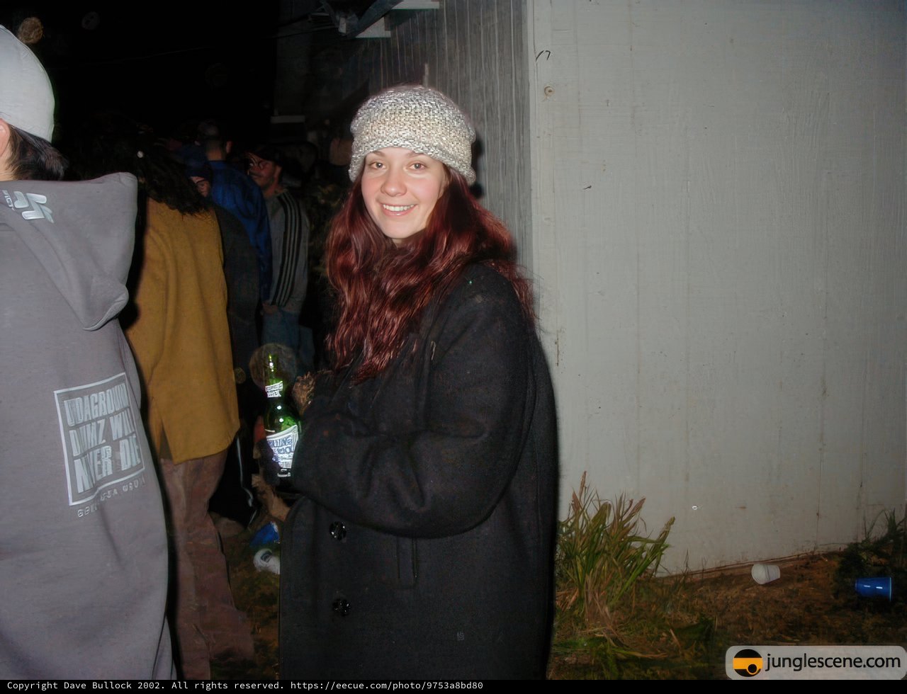 Red-Headed Woman Holding a Beer and Wearing a Beanie
