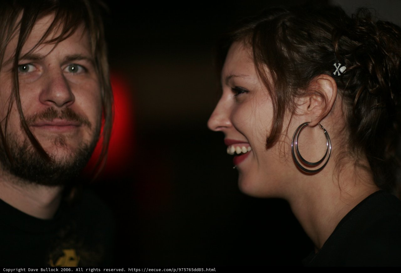 Smiling duo accessorized with art and jewelry