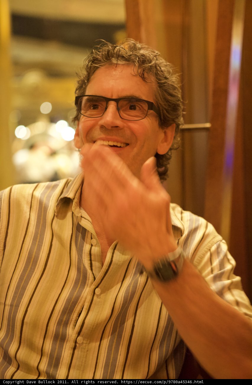 Smiling Man with Glasses and Striped Shirt