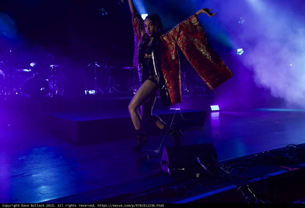 FKA twigs Stunning Dynamic Dance Pose Leg Raised Arms Spread Kimono Flowing Red Brocade Gold Patterns Black Bodysuit Boots Face Visible Band Drums