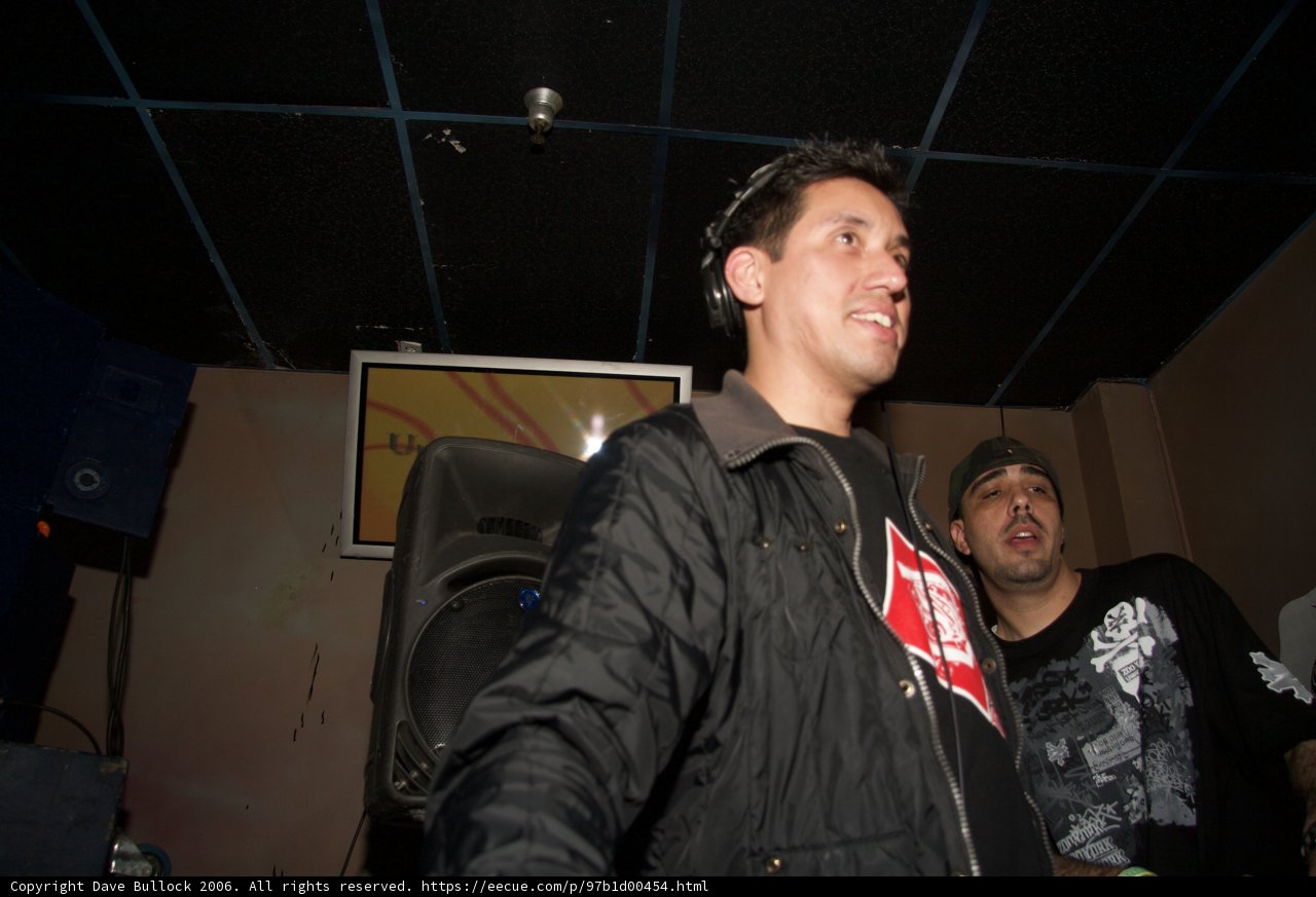 Musician in Black Jacket Performing with Speakers