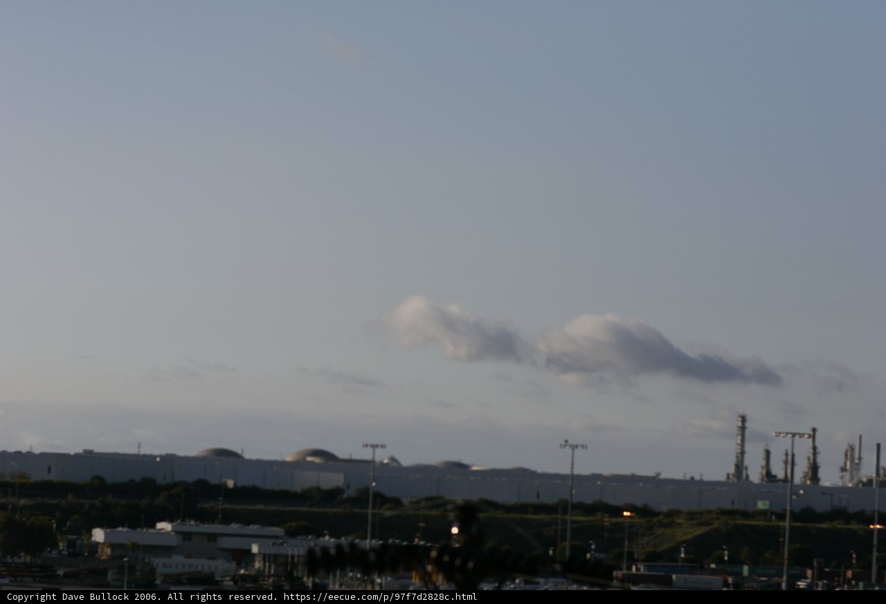 The Towering Factory Under a Cloudy Sky