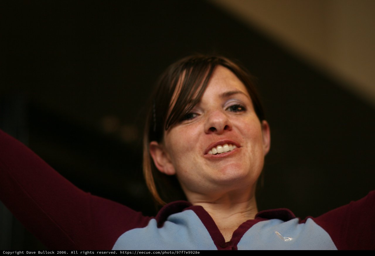 Jubilant Football Fan Celebrating with Arms Raised