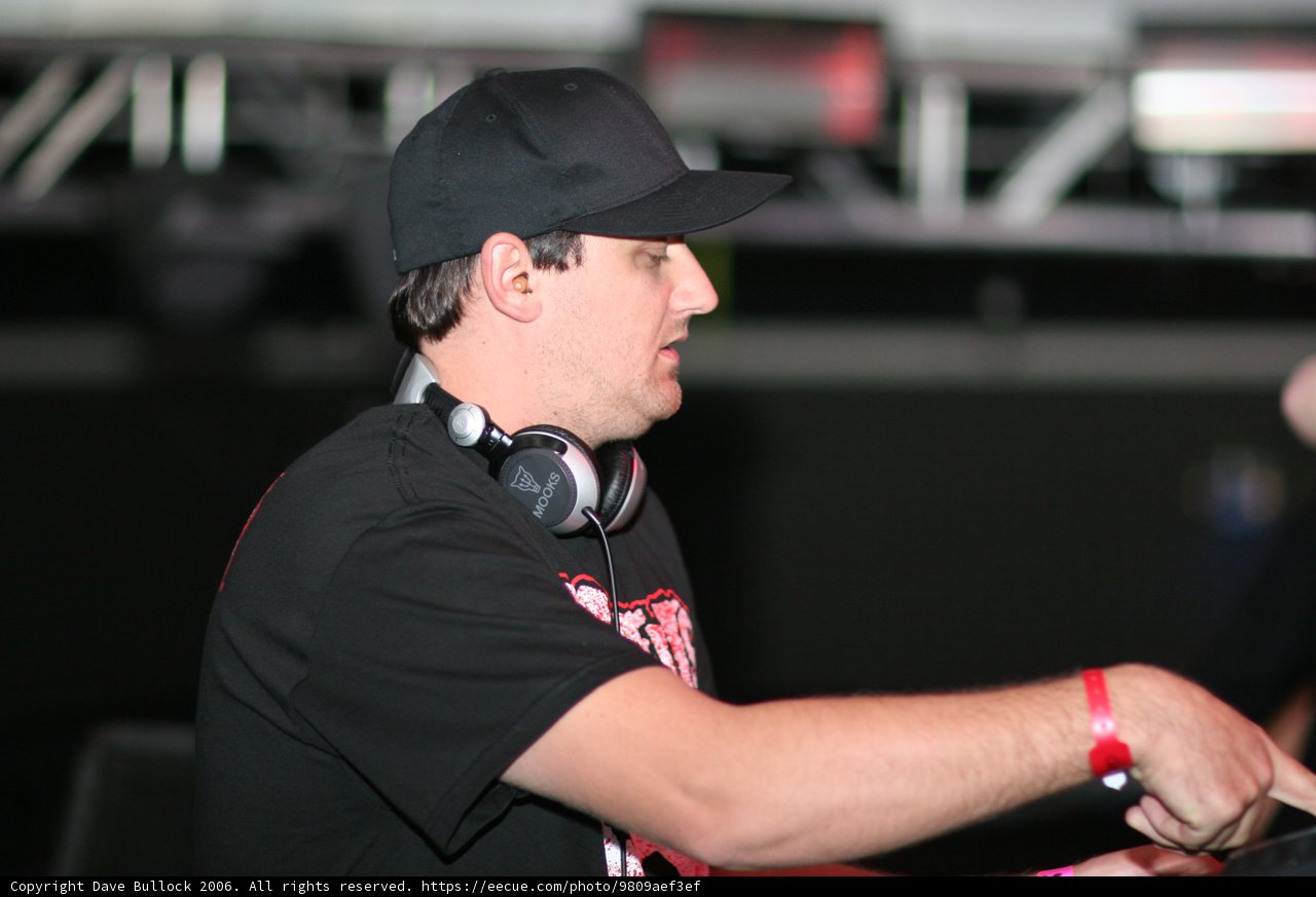 Black Shirted Man with Baseball Cap and Headphones