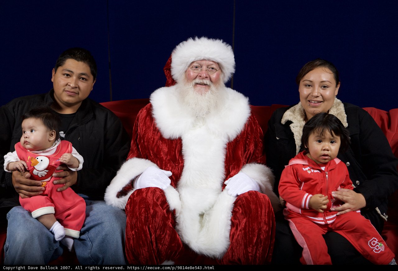 Smiling Family with Santa Claus