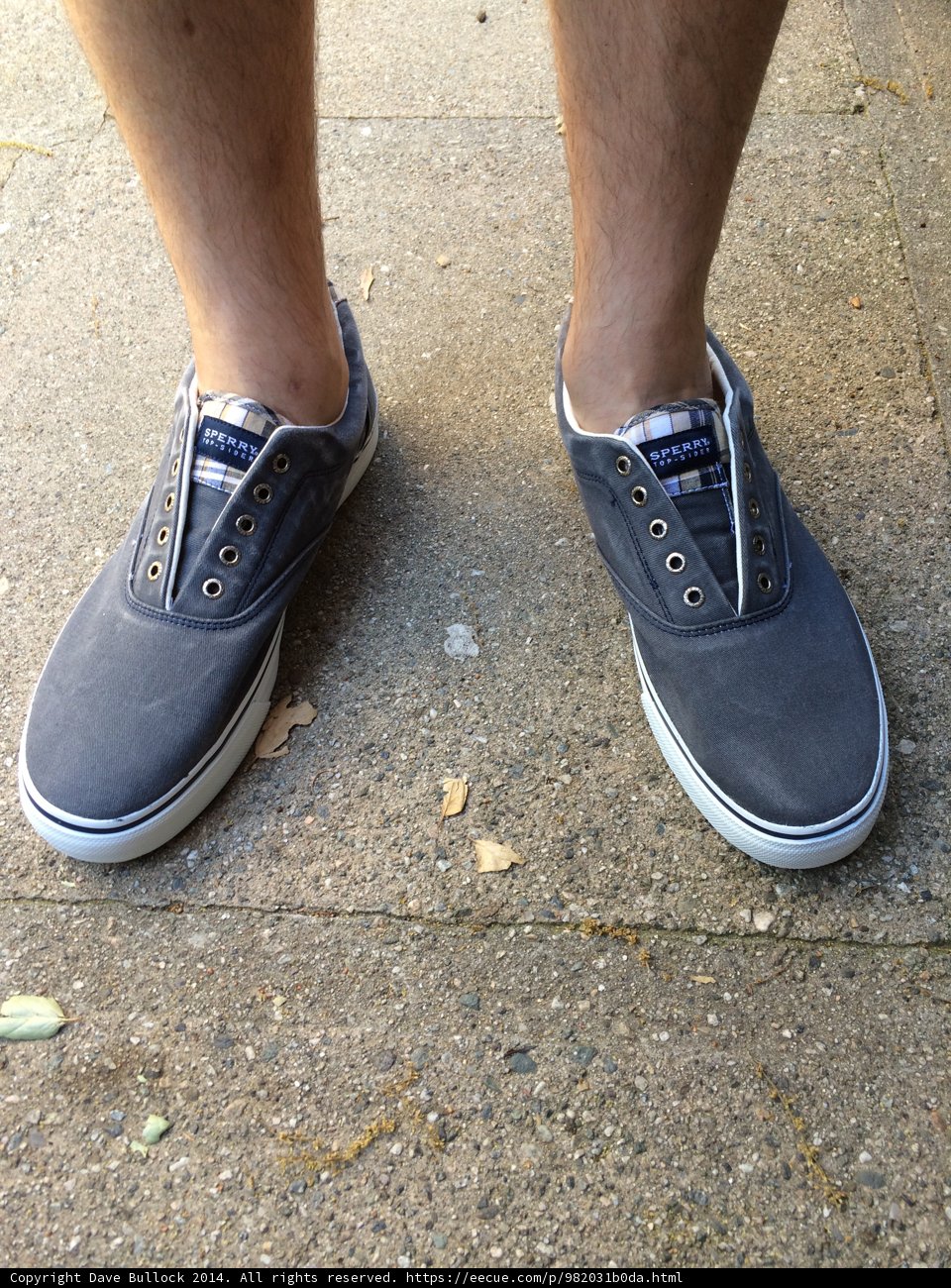 Grey Sneakers on a Sunny Sidewalk