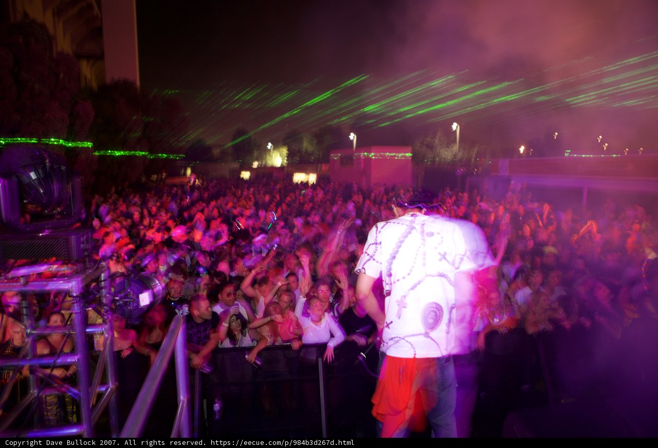 Man on Stage with Energetic Crowd in Night Club