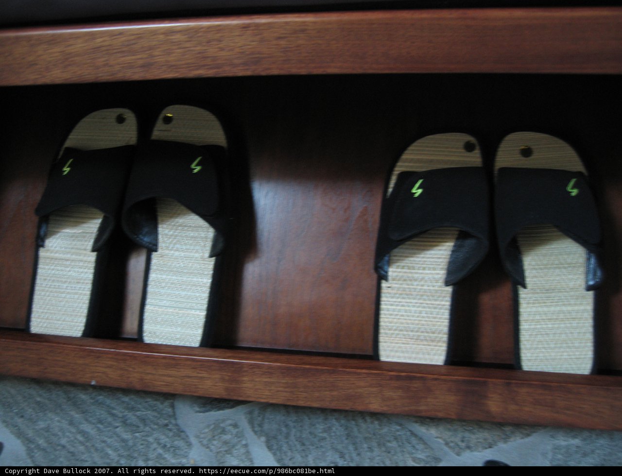 Black and White Sandals on Wooden Shelf