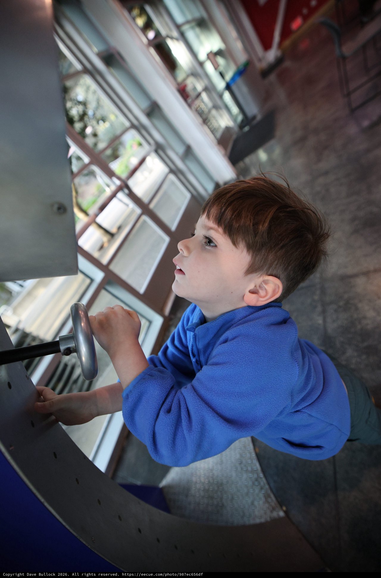 Young Boy Exploring Spiral Staircase at Science Center