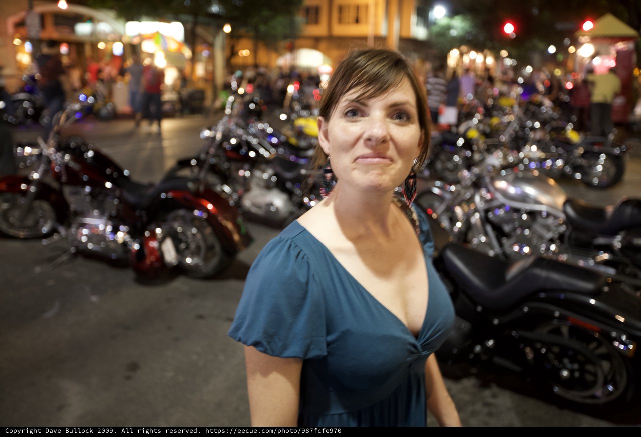 Woman Amid Motorcycles at Night Street Rally