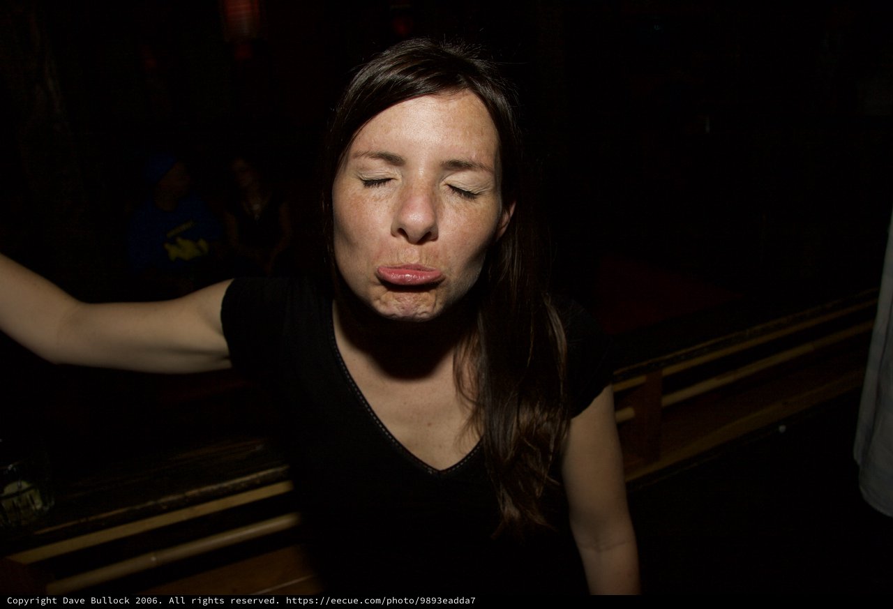 Woman Making a Playful Face at Night Event