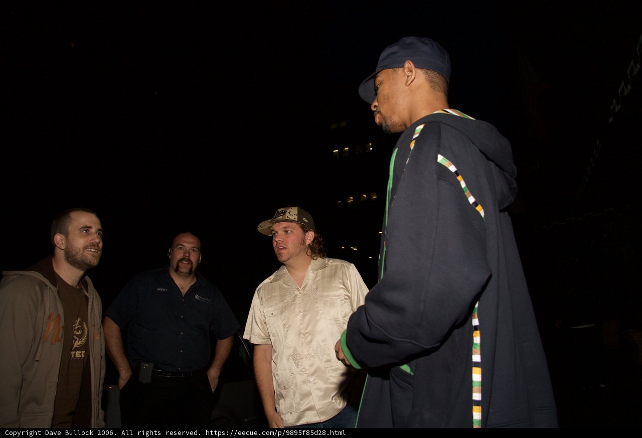 Late Night Conversation Caption: Danny J engages in a deep conversation with his friend while the night sky provides a serene backdrop. Both men sport stylish headgear to keep warm on this chilly night.