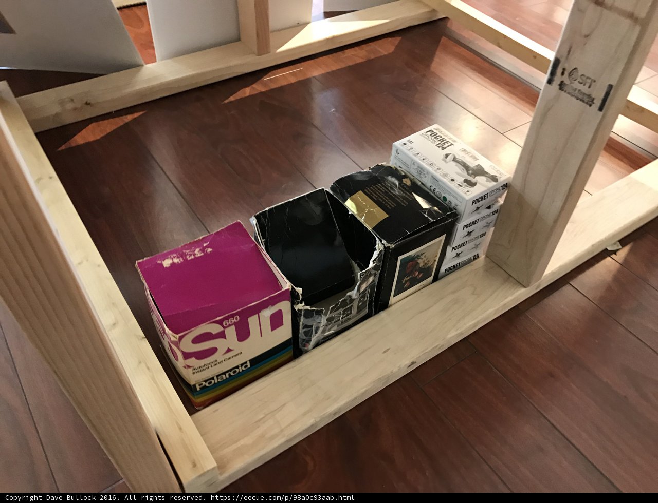 Wooden Shelf with Boxes and a Book