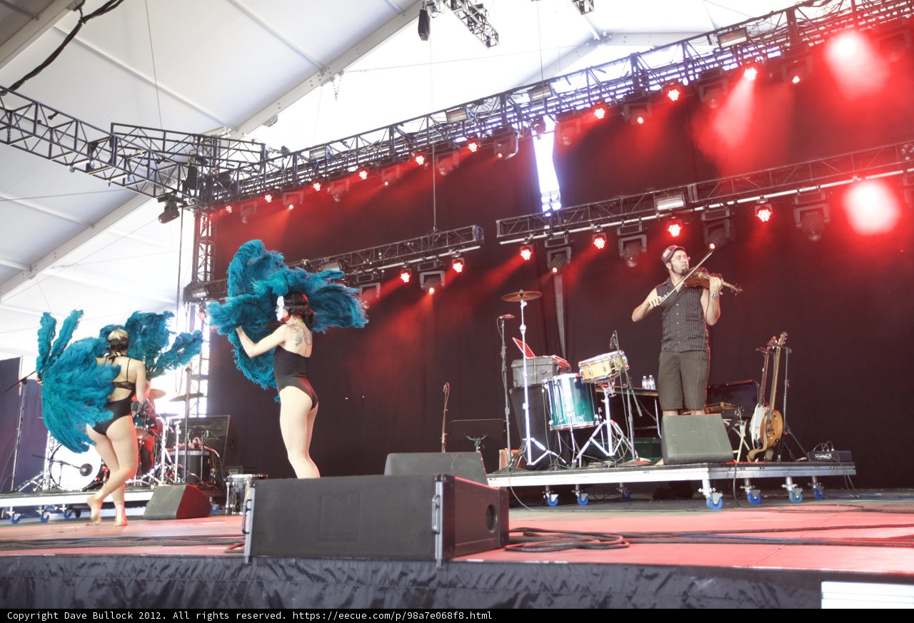 Group of Dancers Perform with Violinist in Concert