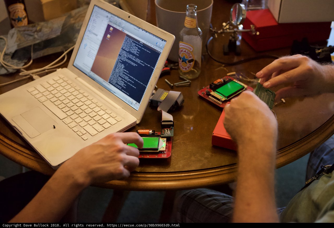 Two People Hard at Work on a Laptop