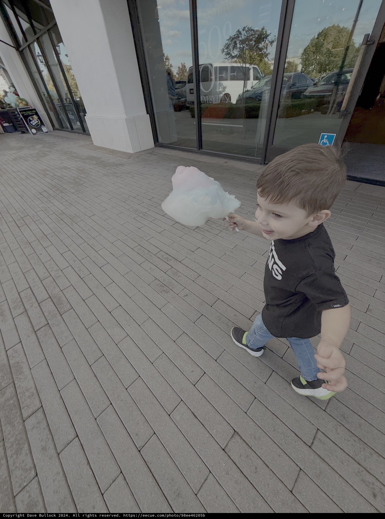 Young Boy Playing with Cotton Candy Outside