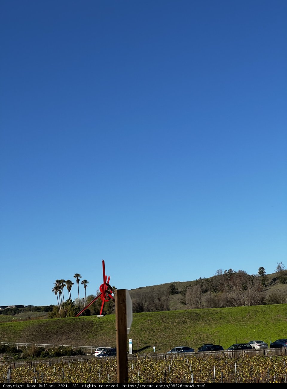 Red Windmill in a Serene Grassland