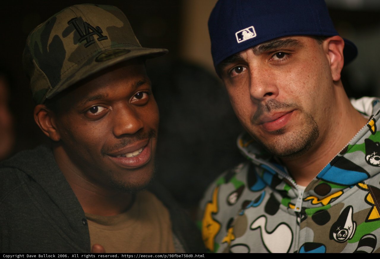 Two Men Showing Off Their Caps