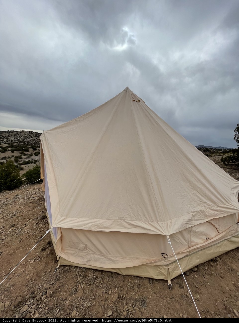 Mountain Tent under a Cloudy Sky