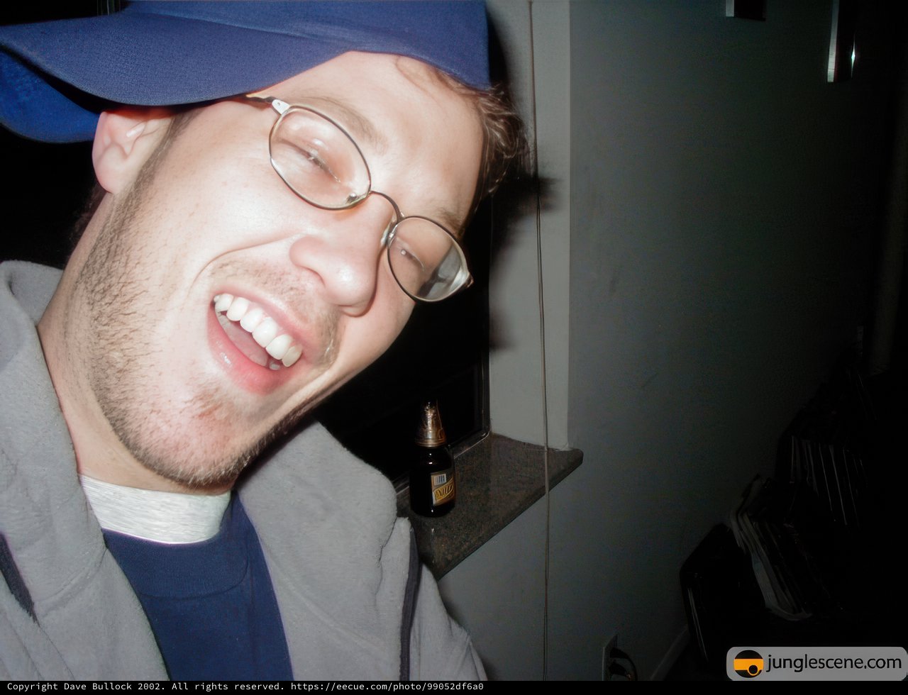 The Smiling Man with Glasses and a Hat