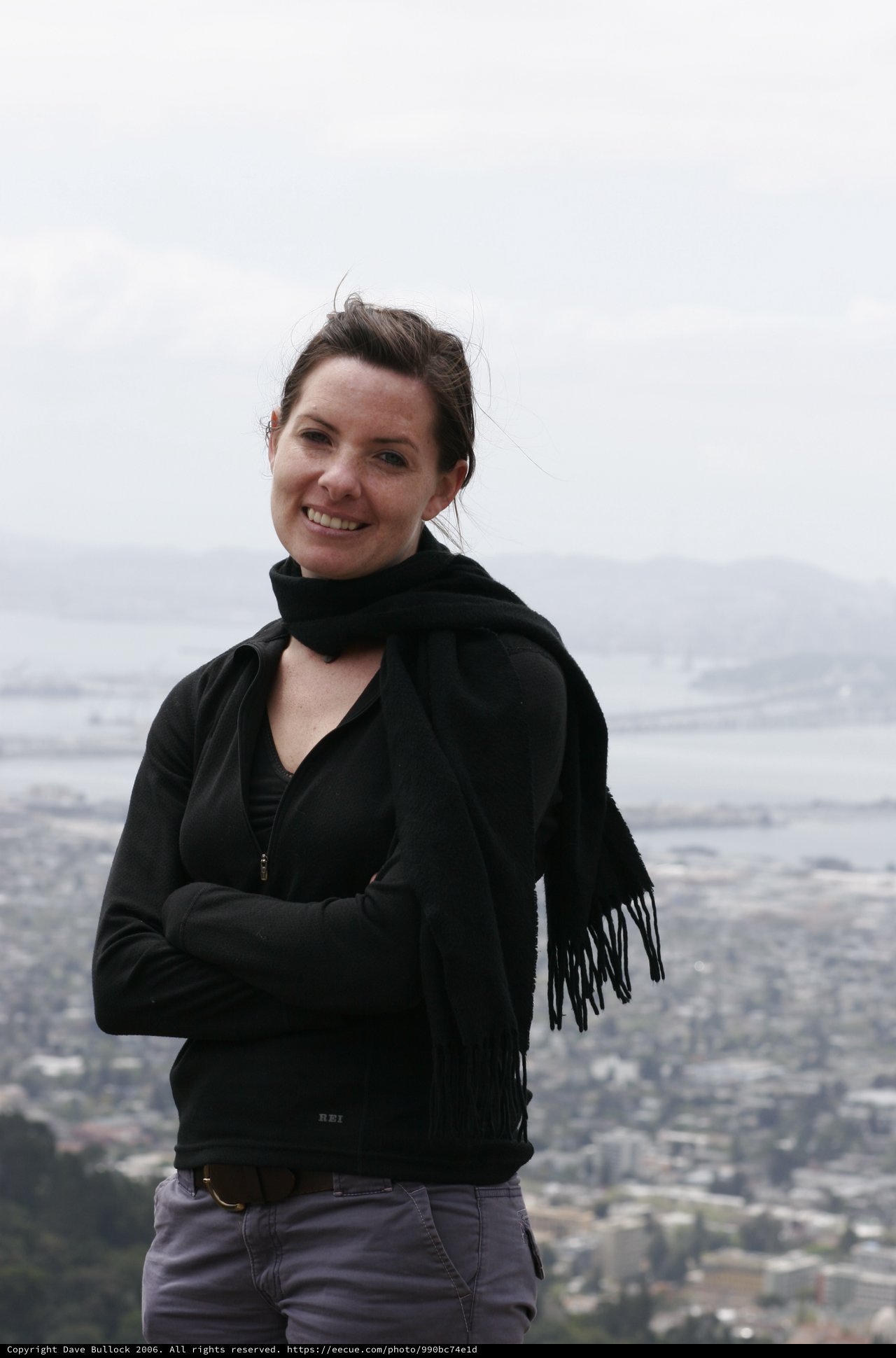 Woman Smiling Atop Hill Overlooking San Francisco Bay