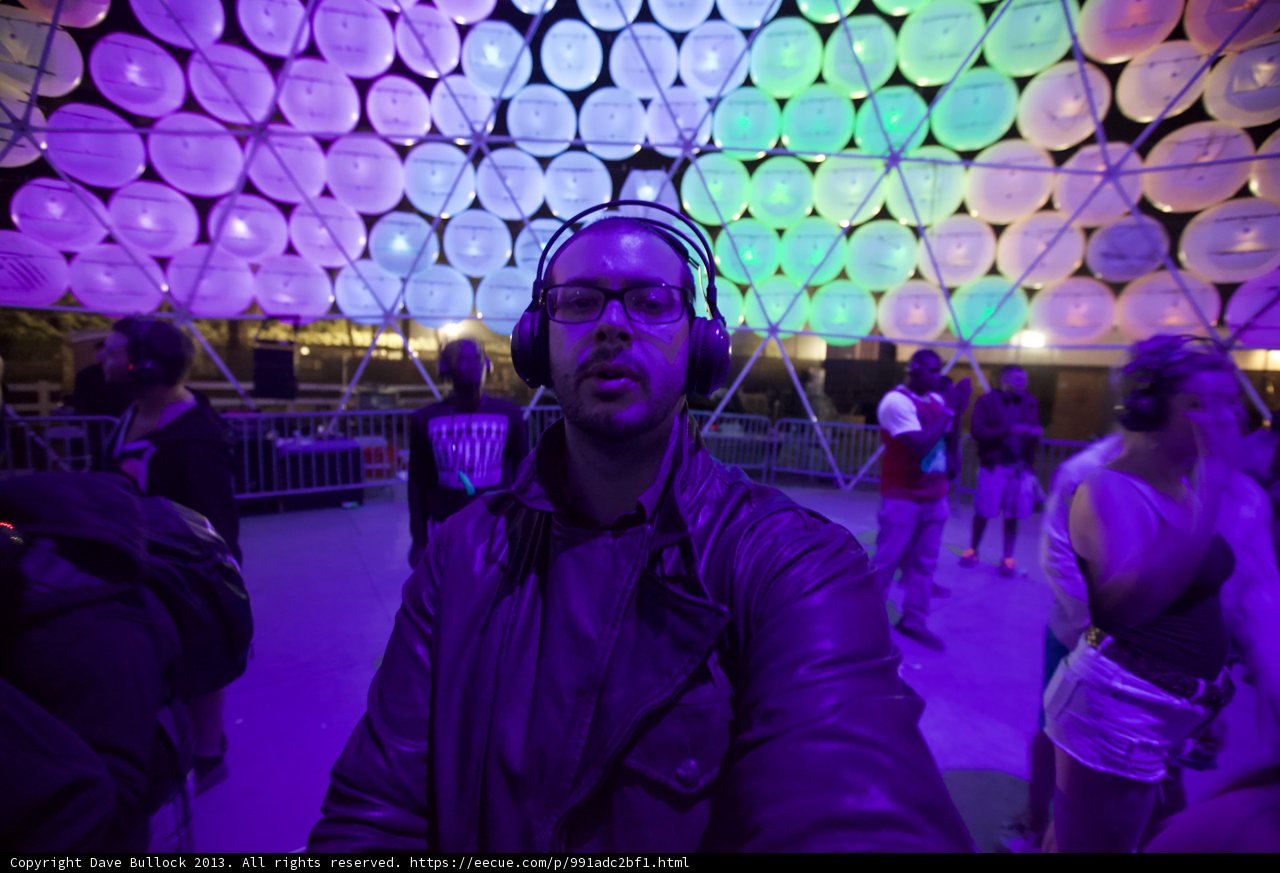 Electrifying Nightlife at Coachella: Man Listening to Music in Front of Large Dome