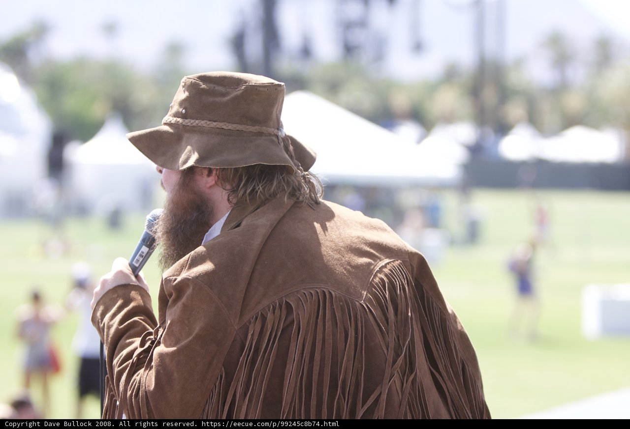 Hat-Wearing Man Addresses the Crowd at Coachella