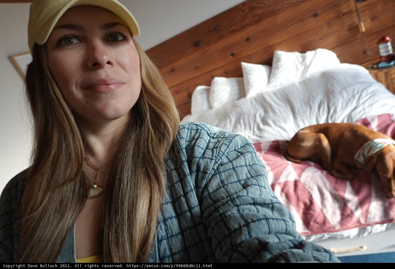 Yellow Hat and Comfy Bed: A Woman and Her Furry Companion