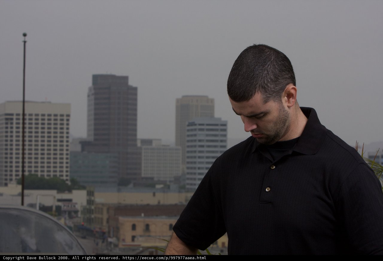 The Man in Black Shirt Stands Tall Amidst the Smog